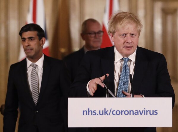 FILE - In this file photo dated Tuesday, March 17, 2020, Britain's Chancellor Rishi Sunak, left, and Prime Minister Boris Johnson arrive for a press briefing about the ongoing situation with the COVID-19 coronavirus outbreak, inside 10 Downing Street in London.  With British Prime Minister Boris Johnson hospitalized and in intensive care Wednesday April 8, 2020, after contracting the new coronavirus, Sunak is among key players in Johnson's Cabinet who will be directing Britain's response to the highly contagious COVID-19 coronavirus, while their leader is being treated. (AP Photo/Matt Dunham, FILE)