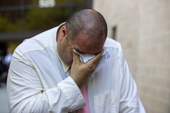 Paul Jamrowski, father of Jordan Anchondo and father in law of Andre Anchondo, who both died in the El Paso Walmart mass shooting, breaks down in tears while speaking to the media outside the federal court in El Paso, Texas, Wednesday, July 5, 2023. Patrick Crusius, who is accused of killing nearly two dozen people in a racist attack at an El Paso Walmart in August 2019, is set to receive multiple life sentences after pleading guilty to federal hate crimes and weapons charges in one of the deadliest mass shootings in U.S. history. (AP Photo/Andrés Leighton)