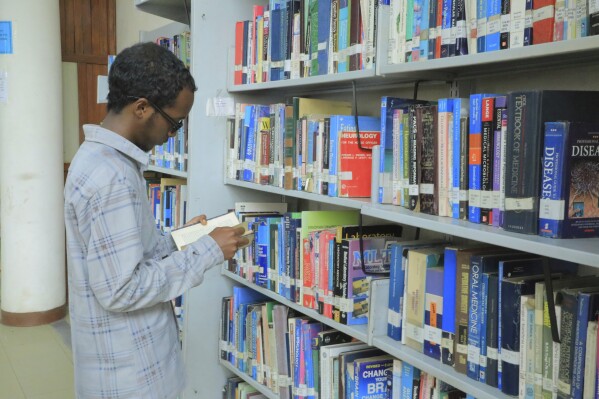 Yonas Nuguse, 21 Years Old, Destined for Harvard University Flicking Through A Book At Wemezeker National Library in Addis Ababa, Ethiopia Friday, May 30, 2025. (Ap Photo/Amanuel Birhane)