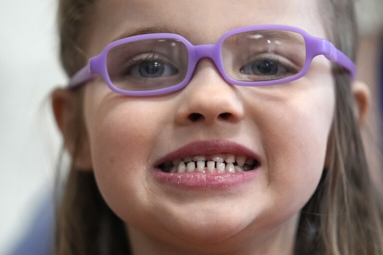 Amber Warner shows her teeth after a dental exam at Christa McAuliffe School in Concord, NH, Wednesday, Feb. 21, 2024. The federal government and the dental community are increasing efforts to reach children at a young age.  (AP Photo/Robert F. Bukaty)