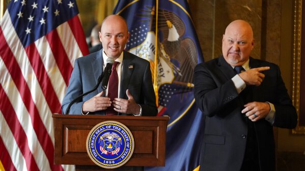 Utah Gov. Spencer Cox, left, speaks during a news conference Tuesday, Aug. 31, 2021, in Salt Lake City. Cox cast doubt on the efficacy of mask-wearing as health leaders made some of their most impassioned pleas yet for state residents to mask up and get vaccinated. Cox, a Republican, said his administration is encouraging people to wear masks but said it is unclear whether they are effective against the highly contagious delta variant of the coronavirus. (AP Photo/Rick Bowmer)