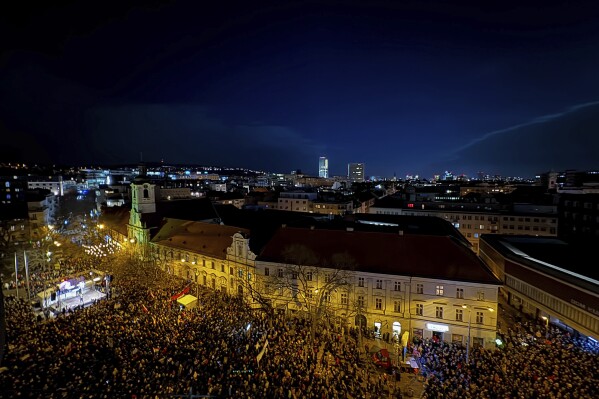 People gather to take part in a protest against a government plan to amend the penal code in Bratislava, on Thursday, Jan. 25, 2024. The changes proposed by the three-party coalition government include a proposal to abolish a special prosecutors' office, which handles serious crimes such as graft, organized crime and extremism. (Pavol Zachar/TASR via AP)