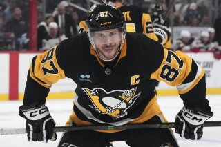 Pittsburgh Penguins' Sidney Crosby prepares to take a face-off during the second period of an NHL hockey game against the New Jersey Devils in Pittsburgh, Saturday, March 15, 2025. (AP Photo/Gene J. Puskar)
