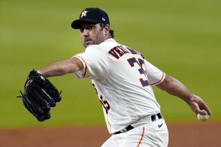 FILE- In this July 24, 2020, file photo, Houston Astros starting pitcher Justin Verlander throws against the Seattle Mariners during the first inning of a baseball game in Houston. Verlander says he feels great following his first bullpen session at 2022 spring training. (AP Photo/David J. Phillip, File)