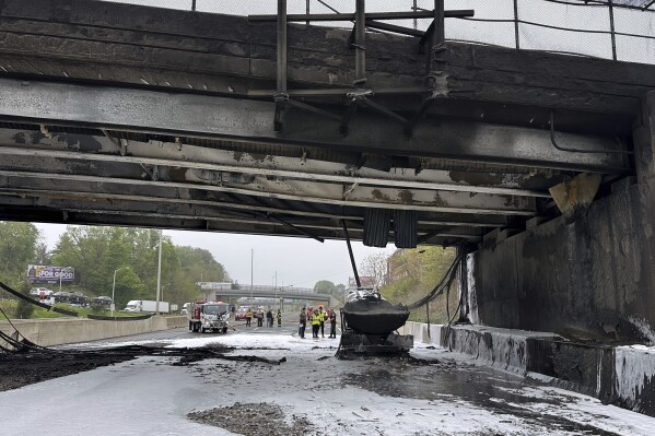 In this image provided by the Connecticut Governor's Office, emergency personnel work at the scene of a fiery early morning crash that left both sides of Interstate 95, the East Coast’s main north-south highway, shut down in southwestern Connecticut., Thursday, May 2, 2024, in Norwalk, Conn. (Norwalk Fire Department/Connecticut Governor's Office via AP)