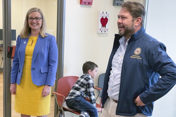 FILE - U.S. Rep. Ruben Gallego, D-Ariz., and his ex-wife, Phoenix Mayor Kate Gallego, tour an affordable housing development in Phoenix along with their 6-year-old son, Michael Gallego, on March 19, 2023. Kate Gallego on Monday endorsed Ruben Gallego's U.S. Senate run, helping him blunt a potential liability after the couple divorced weeks before their child was born. (AP Photo/Jonathan J. Cooper, file)