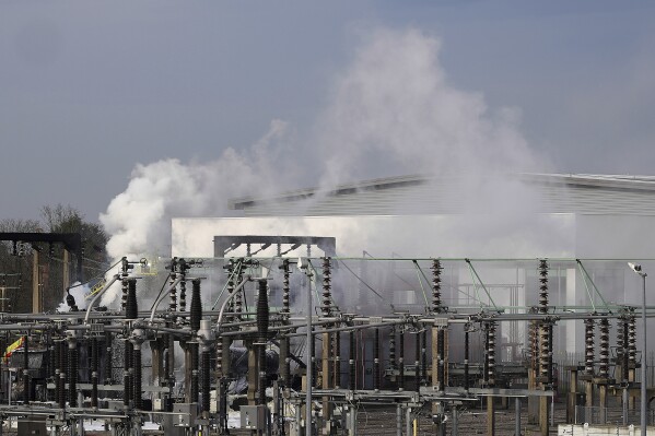 Firefighters extinguish the fire at the North Hyde electrical substation, which caught fire Thursday night and led to a closure of Heathrow Airport in London, Friday, March 21, 2025.(AP Photo/Kirsty Wigglesworth)