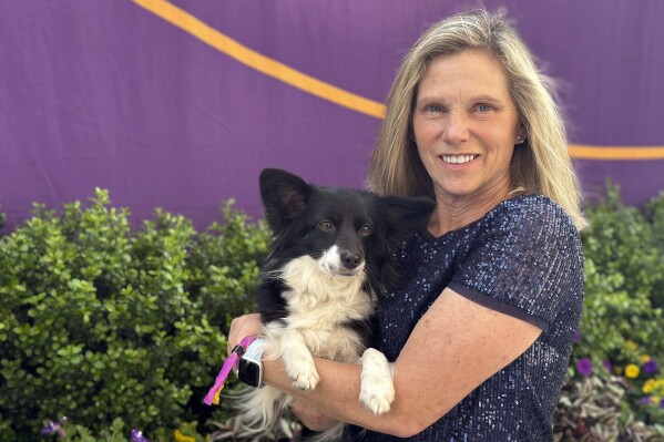 Cynthia Hornor poses with Nimble, the first mixed-breed dog ever to win the Westminster Kennel Club dog show's agility competition, on the show grounds at the USTA Billie Jean King National Tennis Center in New York, Monday, May 13, 2024. (AP Photo/Jennifer Peltz)
