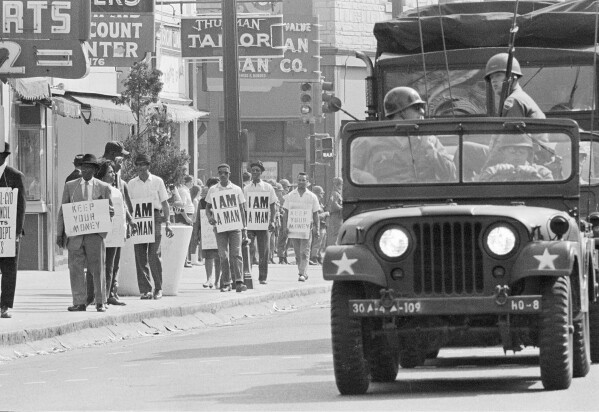 Tennessee National Guard troopers in jeeps and trucks escort a protest march by striking Memphis sanitation workers through downtown Memphis, Tenn., March 30, 1968. (AP Photo, File)