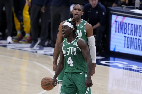 Boston Celtics guard Jrue Holiday (4) celebrates with teammate center Al Horford, rear, during the second half of Game 3 of the NBA Eastern Conference basketball finals against the Indiana Pacers, Saturday, May 25, 2024, in Indianapolis. The Celtics won 114-111.(AP Photo/Darron Cummings)