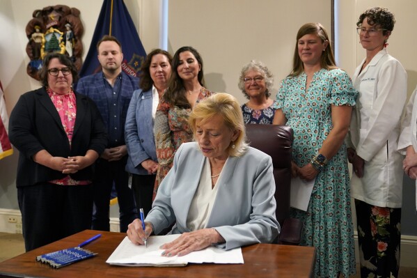 FILE - Maine Gov. Janet Mills signs into law a bill expanding access to abortions later in pregnancy, July 19, 2023, at the State House in Augusta, Maine. Groups opposed to Maine's new law expanding abortion access won't attempt to nullify the statute through a so-called People's Veto referendum. Republican Rep. Laurel Libby, leader of the Speak Up for LIFE group, said Wednesday that allies have decided to focus their resources on electing candidates who are opposed to abortions instead of collecting signatures and running a referendum campaign. (AP Photo/Robert F. Bukaty, File)