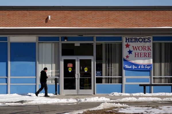 A man arrives at a U.S. post office, Friday, Feb. 21, 2025, in Mission, Kan. (AP Photo/Charlie Riedel)