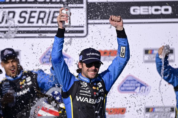 Ryan Blaney celebrates in the victory lane after winning a NASCAR Cup Series auto race at Pocono Raceway, Sunday, July 14, 2024, in Long Pond, Pa. (ĢӰԺ Photo/Derik Hamilton)