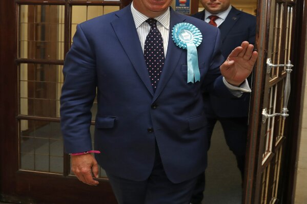 
              Brexit Party leader Nigel Farage smiles as he arrives at the counting center for the European Elections for the South East England region, in Southampton, England, Sunday, May 26, 2019. (AP Photo/Alastair Grant)
            