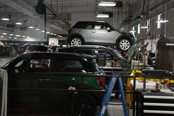 FILE - Cooper models are tended to in the service bay of a Mini dealership Nov. 3, 2022, in Highlands Ranch, Colo. On Friday, June 27, 2024, the government reports on the inflation gauge that the Federal Reserve follows most closely, a data set that will influence the Fed's decision on when to begin cutting interest rates in the coming months. (ĢӰԺ Photo/David Zalubowski, File)