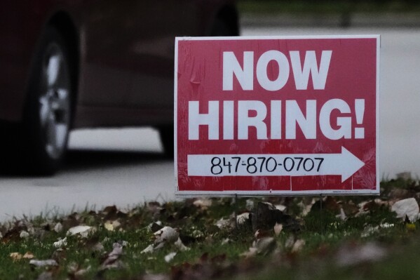 A hiring sign is displayed in Wheeling, Ill., Tuesday, Nov. 7, 2023. On Thursday, the Labor Department reports on the number of people who applied for unemployment benefits last week. (AP Photo/Nam Y. Huh)