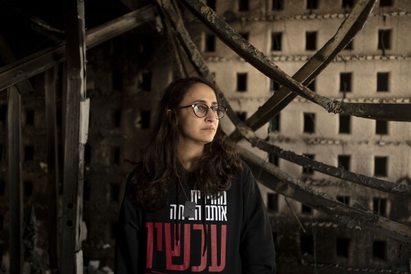 Sharon Alony Cunio weeps as she poses for a portrait in the ruins of her home in Kibbutz Nir Oz, Monday, Jan. 15, 2024, from where she and her family were kidnapped by Hamas militants on Oct. 7, 2023. Cunio and her 3-year-old twin daughters were released in November, but her husband David remains captive in Gaza. (AP Photo/Maya Alleruzzo)