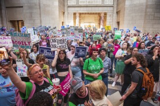 FILE - Protesters chant, "One vote to save our lives," as they are heard in the legislative chamber during a final reading on a bill that combined a 12-week abortion ban with a measure to restrict gender-affirming care for people under 19, May 16, 2023, at state Capitol in Lincoln, Neb. Members of the Nebraska Supreme Court appeared on Tuesday, March 5, 2024, to meet with skepticism a state lawyer's defense of a new law that combines a 12-week abortion ban with another measure to limit gender-affirming health care for minors. (Kenneth Ferriera/Lincoln Journal Star via AP, File)