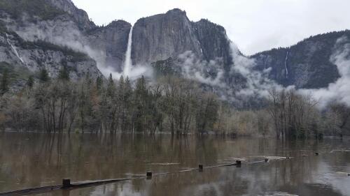 FILE - In this photo released by the National Park Service, floodwaters cover Cooks Meadow and the pedestrian trail through Cooks Meadow in Yosemite Valley in Yosemite, Calif., on April 7, 2018. Much of the famed valley at park will be temporarily closed starting Friday due to a forecast of flooding as rising temperatures melt the Sierra Nevada's massive snowpack. Park officials said Tuesday, April25, 2023, that the eastern section of Yosemite Valley will stay closed at least until May 3. (National Park Service via AP, File)