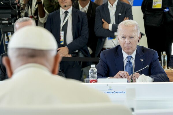 U.S. President Joe Biden listens as Pope Francis speaks during a working session on AI, Energy, Africa and Mideast, at the G7, Friday, June 14, 2024, in Borgo Egnazia, near Bari, southern Italy. (AP Photo/Alex Brandon)