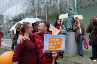 Climate activists gather outside the Supreme Court of the Netherlands, The Hague, on Friday Dec. 20, 2019, ahead of a ruling in a landmark case in which the government was ordered to slash greenhouse gas emissions by 25% by 2020. The government appealed saying that the ruling effectively meant that courts were setting government policy. (AP Photo/Mike Corder)