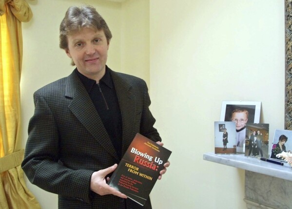 FILE - Alexander Litvinenko, former KGB spy and author of the book "Blowing Up Russia: Terror From Within" is photographed at his home in London, May 10, 2002. In 2006, the Russian defector, former agent for the KGB and its post-Soviet successor agency, the FSB, felt violently ill in London after drinking tea laced with radioactive polonium-210, dying three weeks later. (AP Photo/Alistair Fuller, File)