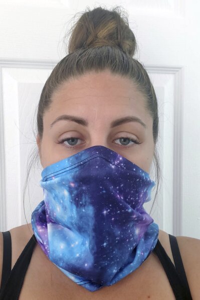 This June 23, 2020 photo provided by Kristen Kowall, 32, of Clearwater, Fla., shows her wearing a mask. In Florida, where many restaurants and bars reopened in early May, Kowall dined out with her fiance in early June. Like others in the restaurant, she didn’t wear a mask. Later she tested positive for COVID-19. “I just feel really groggy and tired. It hurts to walk. Especially my ankles and knees, it feels like my bones are going to fall apart,” she said. “I definitely would advise people from going out. It’s not worth it.” (Kristen Kowall via AP)