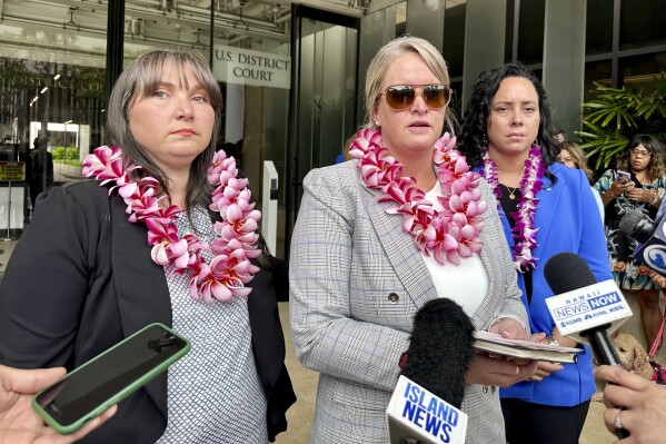 From left, Richelle Dietz, left, Amanda Feindt and Nastasia Freeman stand before reporters at the end of a trial on Monday, May 13, 2024, in Honolulu. They are among the 17 plaintiffs suing the United States over a 2021 jet fuel leak into a Navy water system in Hawaii that sickened thousands of people. (AP Photo/Jennifer Kelleher)