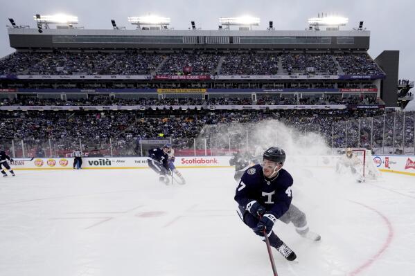 Toronto Maple Leafs forward Pierre Engvall (47) sprays ice as he turns during third-period NHL Heritage Classic hockey game action against the Buffalo Sabres in Hamilton, Ontario, Sunday, March 13, 2022. (Frank Gunn/The Canadian Press via AP)