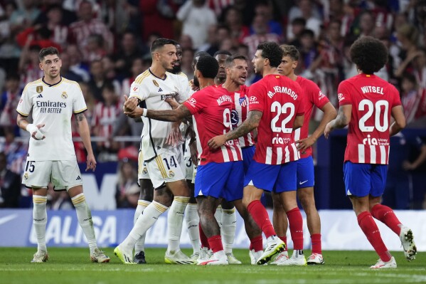 Atletico Madrid players, right, argue with Real Madrid players during the Spanish La Liga soccer match between Atletico Madrid and Real Madrid at Metropolitan stadium in Madrid, Sunday, Sept. 24, 2023. Atletico Madrid won 3-1. (AP Photo/Manu Fernandez)