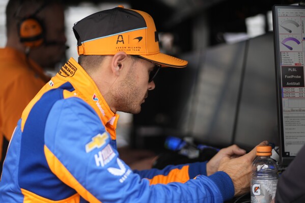 Kyle Larson looks at his phone during a practice session for the Indianapolis 500 auto race at Indianapolis Motor Speedway, Thursday, May 16, 2024, in Indianapolis. (AP Photo/Darron Cummings)