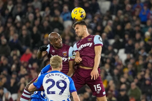 West Ham's Konstantinos Mavropanos, top right, heads the ball during the English Premier League soccer match between West Ham and Brighton, at the London stadium in London, Tuesday, Jan. 2, 2024. (AP Photo/Kirsty Wigglesworth)