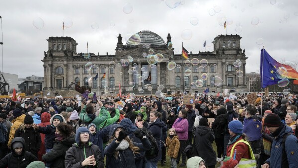 People protest with soap bubbles in front of Germany's parliament Reichstag at a demonstration against the AfD party and right-wing extremism in Berlin, Germany, Saturday, Feb. 3, 2024 (AP Photo/Ebrahim Noroozi)