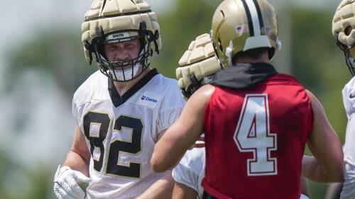 New Orleans Saints tight end Foster Moreau (82) talks with quarterback Derek Carr (4) during NFL football practice in Metairie, La., Tuesday, May 23, 2023. (AP Photo/Gerald Herbert)