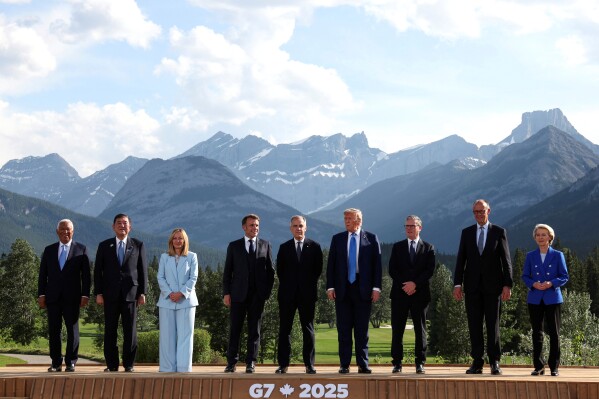 European Council President Antonio Costa, from left, Japan's Prime Minister Shigeru Ishiba, Italian Prime Minister Giorgia Meloni, French President Emmanuel Macron, Canada's Prime Minister Mark Carney, U.S. President Donald Trump, Britain's Prime Minister Keir Starmer, German Chancellor Friedrich Merz and European Commission President Ursula von der Leyen pose for a family photo during the G7 Summit, in Kananaskis, Alberta, Monday, June 16, 2025. (Suzanne Plunkett/Pool Photo via AP)