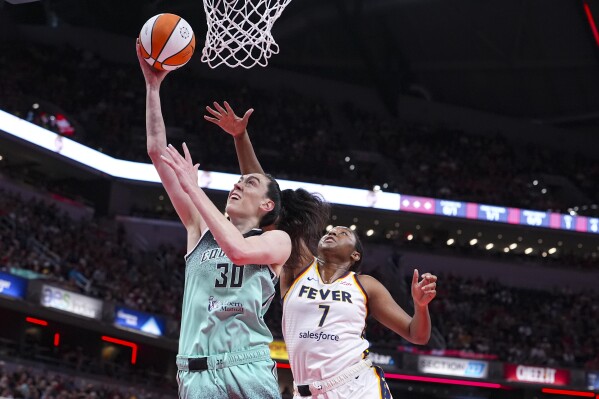 New York Liberty forward Breanna Stewart (30) shoots in front of Indiana Fever forward Aliyah Boston (7) in the first half of a WNBA basketball game in Indianapolis, Saturday, May 24, 2025. (AP Photo/Michael Conroy)