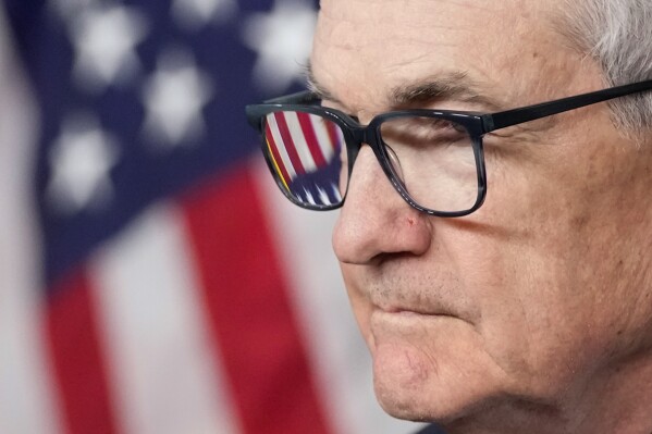 FILE - An American flag is seen in Federal Reserve Board Chair Jerome Powell's glasses as he speaks at a news conference at the Federal Reserve, Dec. 13, 2023, in Washington. On Wednesday, March 6, 2024, Powell testifies to the House Financial Services Committee on the first of two days of semi-annual testimony to Congress. (AP Photo/Alex Brandon, File)