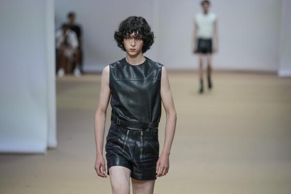 Man with black leather Prada bag before Prada fashion show, Milan