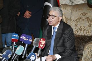 FILE - Fathi Bashagha holds a news conference after east-based lawmakers named Bashagha to replace then Prime Minister Abdul Hamid Dbeibah as head of a new interim government, in Tripoli, Libya, Feb. 10, 2022. Libyan lawmakers confirmed a new transitional government Tuesday, March 1, 2022, a move that is likely to lead to parallel administrations and fuel mounting tensions in a country that has been mired in conflict for the past decade. Prime Minister-designate Fathi Bashagha submitted his Cabinet to the east-based House of Representatives where 92 of 101 lawmakers in attendance approved it, during a vote that was broadcast live. (AP Photo/Yousef Murad, File)