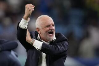FILE - Australia's head coach Graham Arnold gestures at the end of the World Cup group D soccer match between Australia and Denmark, at the Al Janoub Stadium in Al Wakrah, Qatar, on Nov. 30, 2022. Arnold is set to become the first man to lead Australia at successive FIFA World Cups after signing a four-year contract extension as national men’s coach which will take him through the 2026 world tournament. (AP Photo/Thanassis Stavrakis, File)