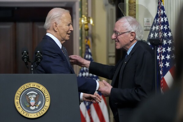 President Joe Biden stands with Sen. Bernie Sanders, I-Vt., after speaking about lowering health care costs in the Indian Treaty Room at the Eisenhower Executive Office Building on the White House complex in Washington, Wednesday, April 3, 2024. (AP Photo/Mark Schiefelbein)