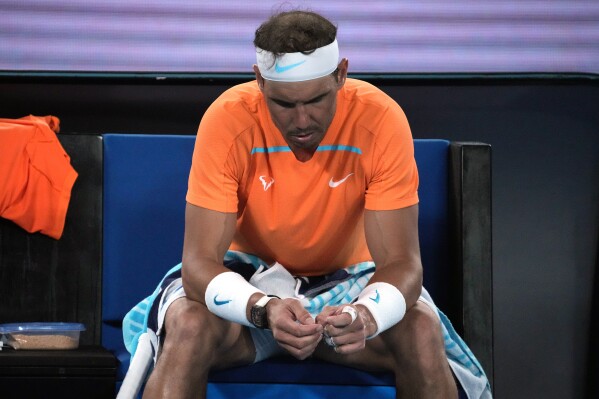 FILE - Rafael Nadal of Spain reacts during his second round loss to Mackenzie McDonald of the U.S. at the Australian Open tennis championship in Melbourne, Australia, Wednesday, Jan. 18, 2023. Rafael Nadal pulled put of the Monte Carlo Masters on Thursday, April 4, 2024, because of a lingering injury, delaying the start of his clay-court tournament preparation ahead of the French Open and extending his absence that began in January. (AP Photo/Dita Alangkara, File)