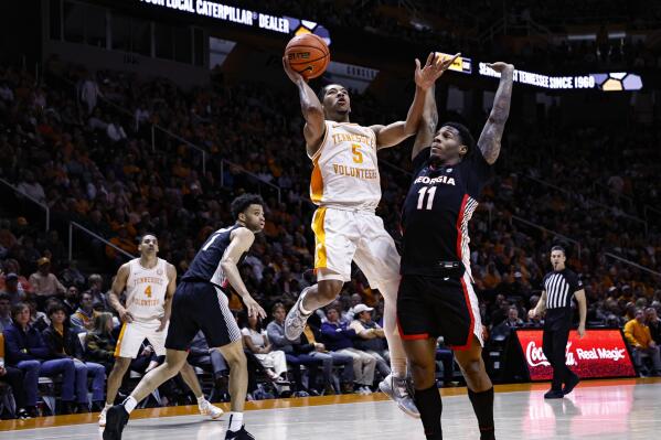 Tennessee guard Zakai Zeigler (5) shoots over Georgia guard Justin Hill (11) during the first half of an NCAA college basketball game Wednesday, Jan. 25, 2023, in Knoxville, Tenn. (AP Photo/Wade Payne)