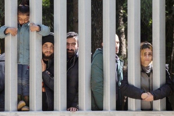 FILE - Members of a group of some 30 migrants seeking asylum are seen in Bialowieza, Poland, on May 28, 2023. Refugee rights activists on Monday May 13, 2024 criticized Poland's pro-European Union government for plans to toughen measures along the border with Belarus and for continuing a policy initiated by the previous populist government of pushing migrants back across the border there. (AP Photo/Agnieszka Sadowska, File)
