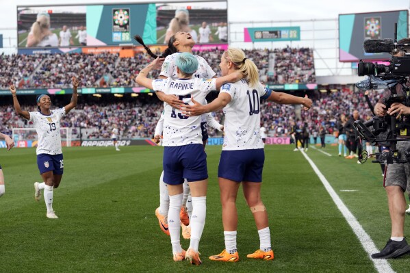 United States' Lindsey Horan (10), Megan Rapinoe (15) and Sophia Smith top, celebrate after Horan scored their third goal during the second half of the Women's World Cup Group E soccer match between the United States and Vietnam at Eden Park in Auckland, New Zealand, Saturday, July 22, 2023. (AP Photo/Abbie Parr)