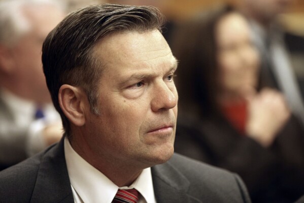 Kansas Attorney General Kris Kobach follows a legislative committee hearing, Wednesday, Feb. 7, 2024, at the Statehouse in Topeka, Kan. The Kansas Supreme Court has granted Kobach's request to end a long-running lawsuit against the state over school funding because lawmakers have increased aid to local school districts. (AP Photo/John Hanna)