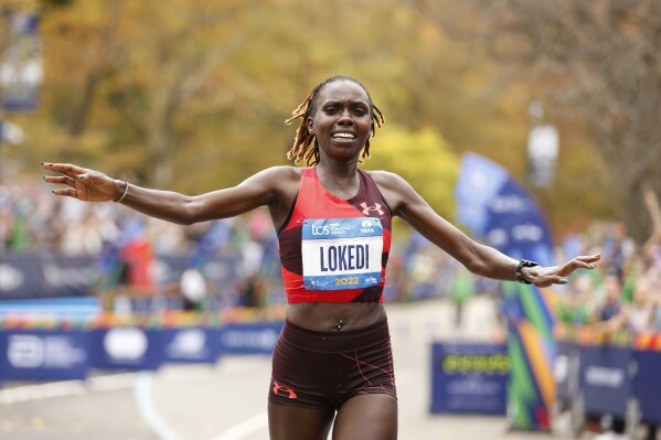 FILE - Sharon Lokedi, of Kenya, crosses the finish line first in the women's division of the New York City Marathon, Sunday, Nov. 6, 2022, in New York. Lokedi is set to defend her New York City Marathon title in the race Nov. 5 as part of a loaded women's professional field. (AP Photo/Jason DeCrow, File)