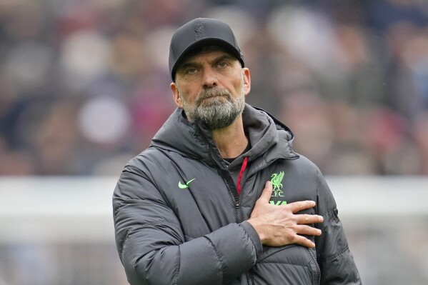 Liverpool's manager Jurgen Klopp gestures to fans at the end of the English Premier League soccer match between West Ham United and Liverpool at London stadium in London, Saturday, April 27, 2024. The match ended in a 2-2 draw. (AP Photo/Kin Cheung)