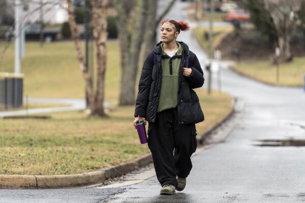 Kailani Taylor-Cribb walks through her neighborhood in Asheville, N.C., on Tuesday, Jan. 31, 2023. Kailani hasn’t taken a single class in what used to be her high school since the height of the coronavirus pandemic. She vanished from the public school roll in Cambridge, Mass., in 2021 and has been, from an administrative standpoint, unaccounted for since then. (AP Photo/Kathy Kmonicek)