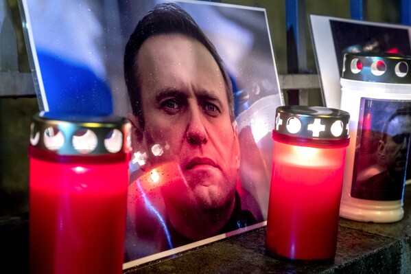 Candles and a photo of jailed Russian opposition leader Alexei Navalny, who has died in a Russian prison, according to the Federal Penitentiary Service, are placed at the fence of the meanwhile closed Russian consulate in Frankfurt, Germany, Friday, Feb. 16, 2024. (APPhoto/Michael Probst)